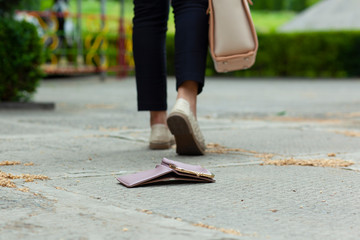 wallet in ground and woman in street