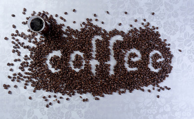 Coffee beans forming the word coffee on a white background.