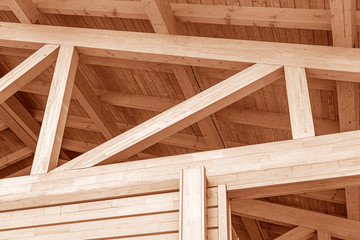 The construction of the wooden roof. Detailed photo of a wooden roof overlap construction.