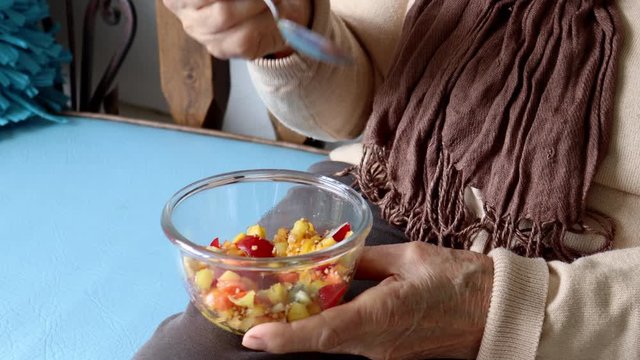 Senior woman at home eating fruit. Healthy eating or healthy lifestyle concept