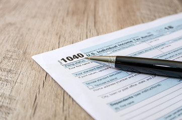 tax form 1040 with a black pen.