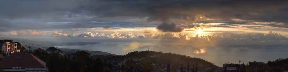 Obraz premium Panoramic view at dusk of lebanese shore with beirut in a far end