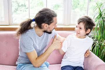 Father's day. Happy funny family dad and son spending their time together. A loving father encourages his son. Family smiling and having fun.