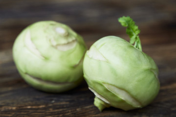 Two raw kohlrabies on a rustic wooden table. Healthy food. Vegan, diet.