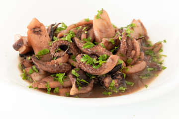 Close up of cooked cuttlefish on white plate
