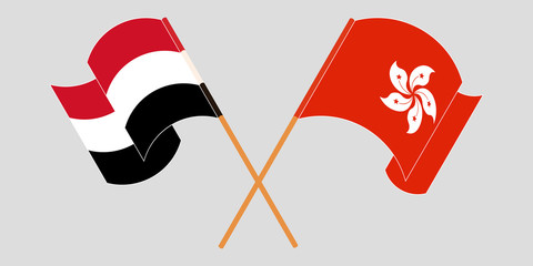 Crossed and waving flags of Hong Kong and Yemen