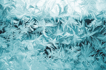 Winter texture of frost on the glass window as a background.