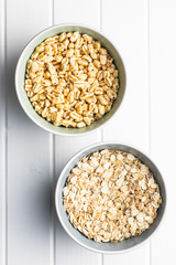 Puffed wheat covered with honey and oatmeals in bowls.