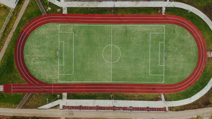 Sports stadium for soccer and Jogging in the summer. Top view of green field with a quadcopter