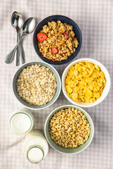 Various breakfast cereals in bowls. Puffed wheat and oatmeals.