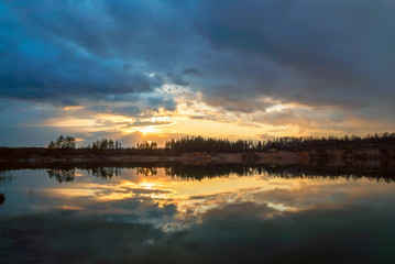 Fototapeta na wymiar Spring sunset over the lake in calm weather . Vsevolozhsk. Leningrad region .