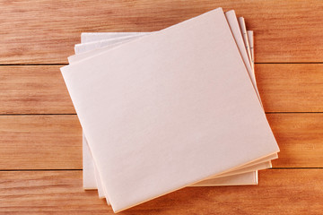 Top View of a Blank Newspaper on Wooden Desk or Table. Reading the News. Pen, Pencil, a Blank Notebook. Cup of coffe. Calculator. Copy space for text or Image.