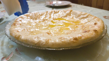 Selective focus. The national Ossetian dish is the Ossetian pie. Thin dough and melted butter. Juicy fatty food