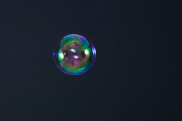 Beautiful rainbow soap bubble on a black background