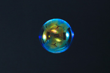 Beautiful rainbow soap bubble on a black background