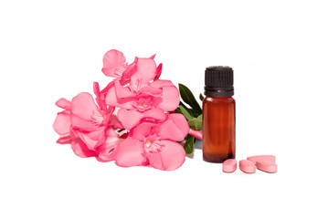 photo of cosmetic bottle with oil and pink pills and flowers isolated, on a white background. herbal vitamins