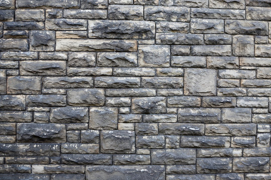 Textured stone wall background. Square patterns and rough texture