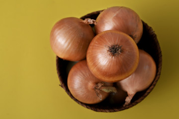 yellow onions isolated on yellow background
