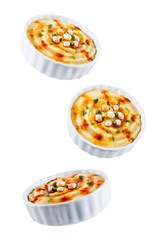 Hummus appetizer in a white bowl on a white isolated background