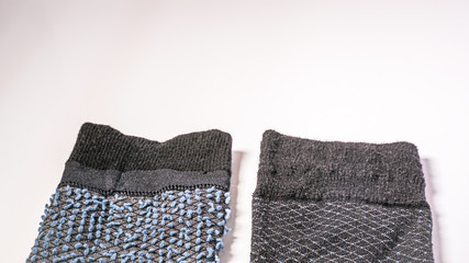 Non matching socks on a white background.