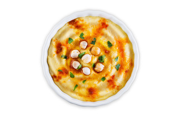 Hummus appetizer in a white bowl on a white isolated background