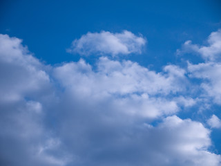 Naklejka na ściany i meble Beautiful blue sky with white and fluffy clouds