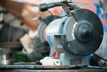 A grinding machine on the workbench close up.
