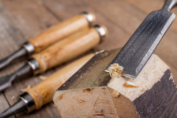 Work with a carpenter's chisel in pine wood. Small carpentry work in the home workshop.