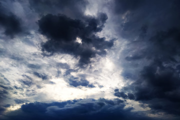 Obraz premium The sky before a thunderstorm. Black clouds with a blue tint. The beginning of the rain.