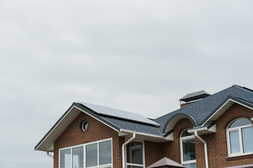 Sun solar panels on roof of house. Sun solar panels electricity sustainability of planet. Alternative power plant. Renewable green energy for home.