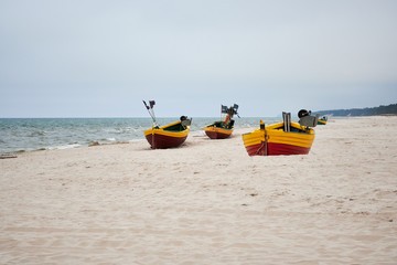 Fishing boats on the beach on a cloudy and foggy day. Baltic Sea, Poland