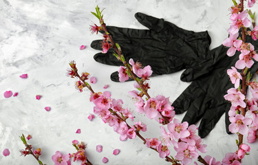 Black gloves and flowering branch