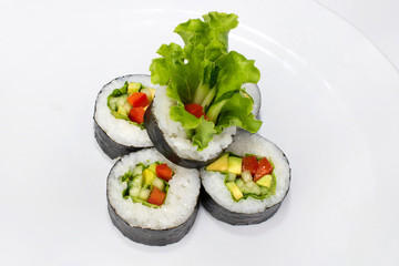 Japanese vegetable roll for vegetarians from rice, nori, avocado, cucumber, paprika and lettuce on a white background