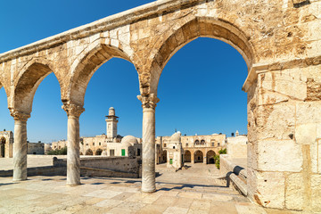 Ancient stone arches and minaret in Old City of Jerusalem.