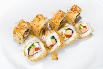 Japanese roll of rice, chukka, cream cheese, bell pepper, fried salmon and tuna flakes on a white background