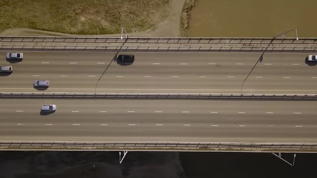 A flying camera takes the center of the city overlooking city traffic and a landmark.