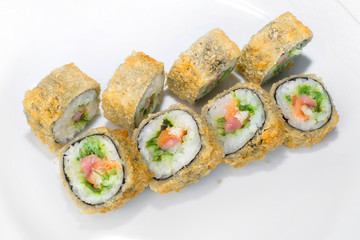Traditional Japanese roll of rice, eel, salmon, tuna and chuka seaweed on a white background