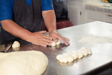 Detail of male hands preparing bread dough - baked wheat bread - Happy Hispanic adult man preparing bread dough
