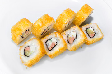 Japanese roll of takuan, tuna, rice and cream cheese on a white background