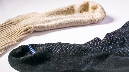 Non matching socks on a white background.