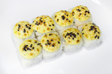 Japanese roll Kin of rice, crab meat, sesame seeds, white sauce on a white background
