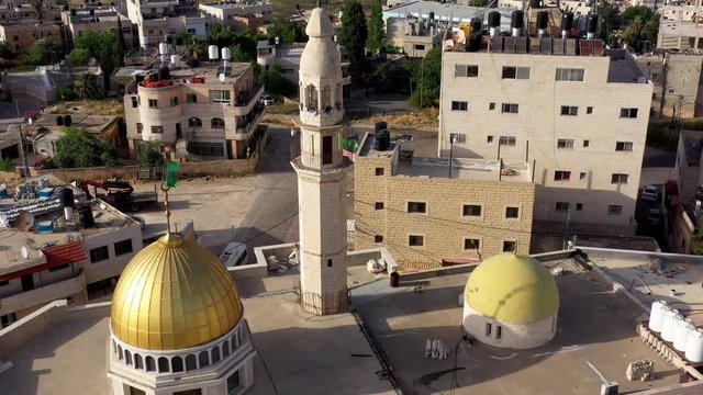 Aerial View over Golden Dome Mosque with hamas green flag in Palestine Town Biddu,Near Jerusalem