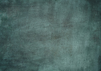 Background texture of a blue wall with dots, scratches and brush strokes. The old wall of the building without repair with unique patterns. Beautiful background for advertising a product, text, image