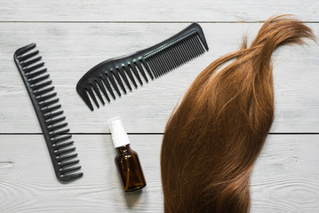 Obraz premium Female hair and a hairbrush on the hairdresser table background.
