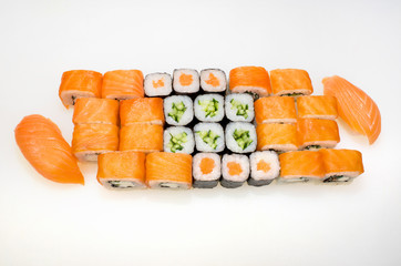 Classic traditional Japanese set of rice, nori, salmon, avocado, eel, cucumber and sushi with salmon on a white background