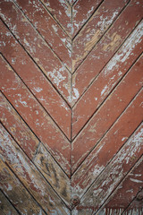 Background texture of a wooden old red parquet floor with peeling paint. Beautiful floor pattern from vintage parquet. Floor of an old building. wooden parked boards laid at an angle.