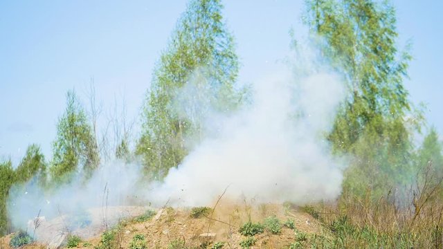 Smoke explosion in slowmotion outdoors at the summer day, high speed