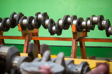 Dismantled locomotive driver. Engine parts lie on a table in a factory