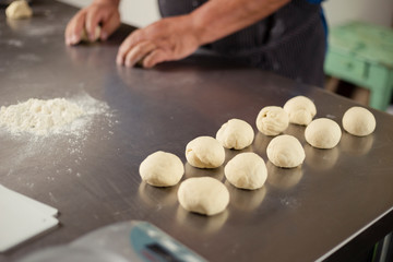 Detail of ready to bake bread dough - Male hands preparing dough - baked wheat bread