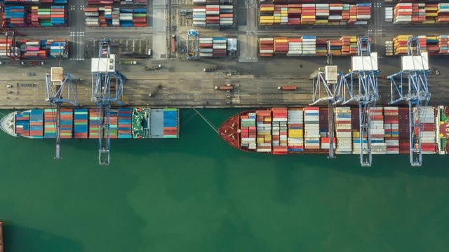 Container ship in export and import business and logistics. Shipping cargo to harbor by crane. Water transport International. Aerial view and top view.
